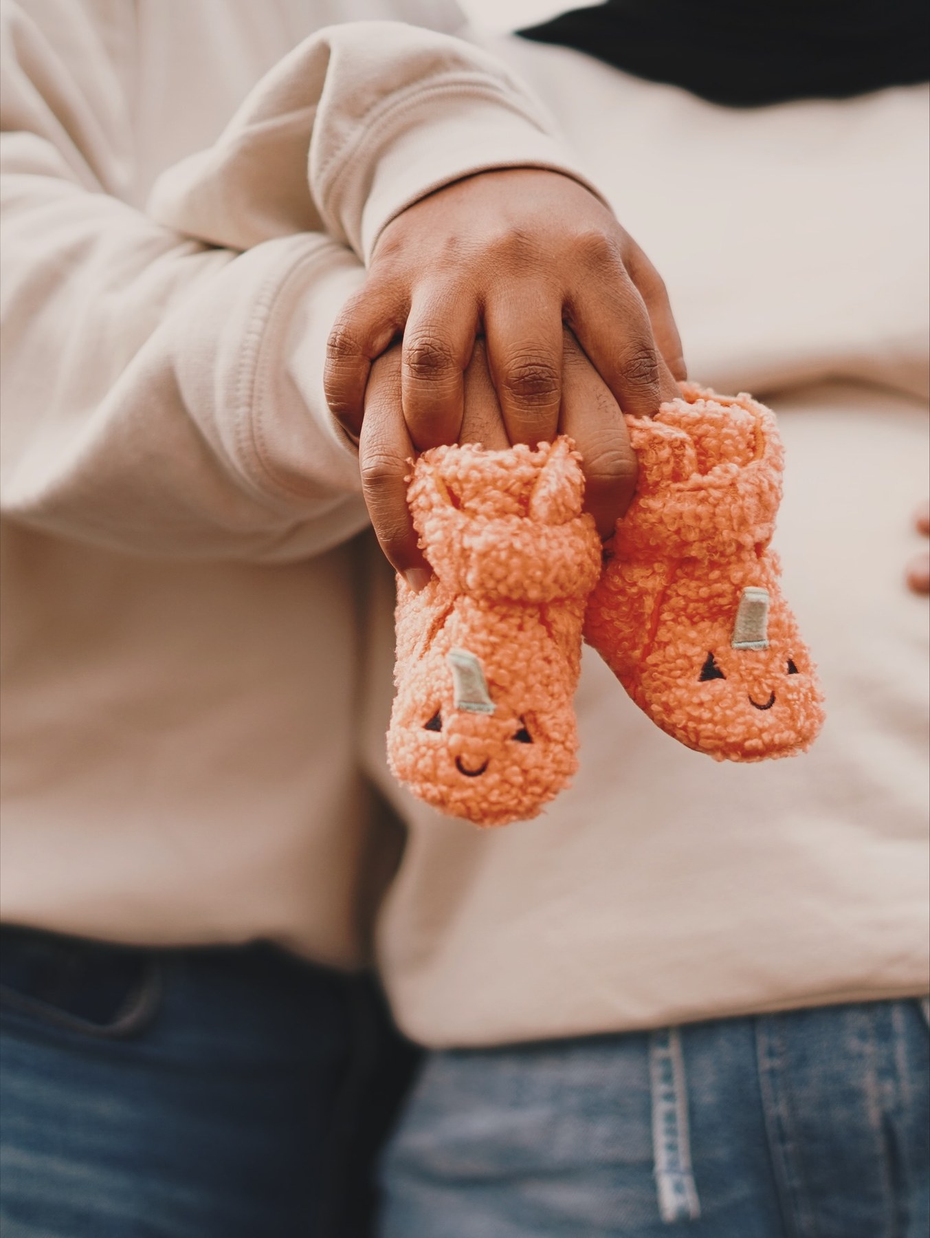 Parents holding baby shoes